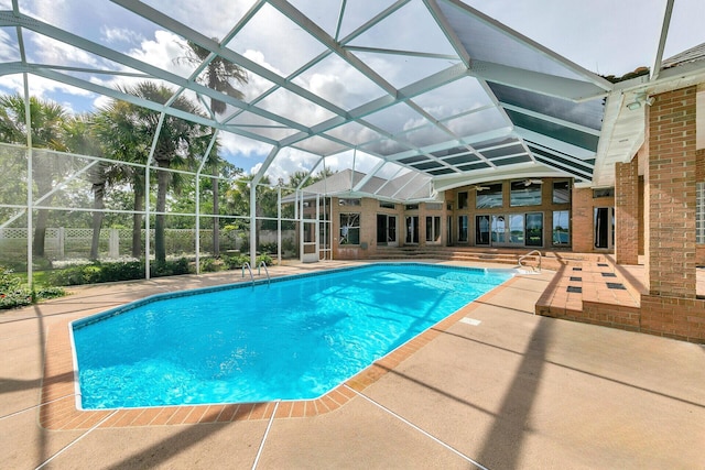 view of pool with a patio and a lanai