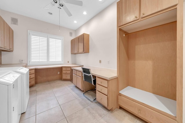 kitchen with light tile patterned flooring, washing machine and clothes dryer, built in desk, light brown cabinets, and ceiling fan