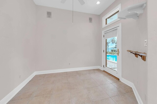 interior space with ceiling fan, a healthy amount of sunlight, and light tile patterned flooring