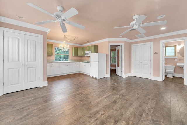 unfurnished living room with crown molding, a healthy amount of sunlight, and dark hardwood / wood-style floors