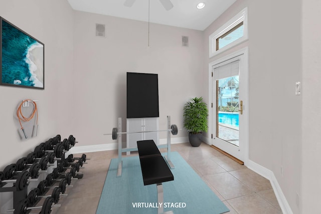 workout room with light tile patterned floors and ceiling fan