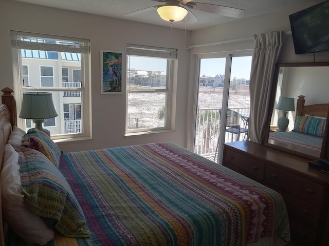 bedroom featuring ceiling fan, access to exterior, and multiple windows