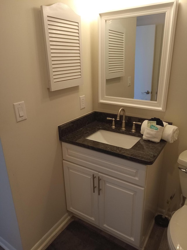 bathroom with toilet and vanity