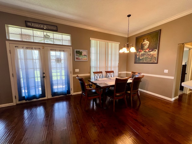 dining room with dark hardwood / wood-style floors, crown molding, and a wealth of natural light