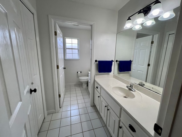 bathroom featuring tile patterned flooring, vanity, and toilet