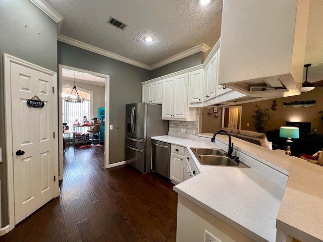 kitchen featuring dark wood-type flooring, sink, a textured ceiling, and white cabinetry