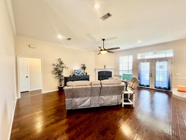 living room featuring a textured ceiling, crown molding, ceiling fan, and dark hardwood / wood-style flooring