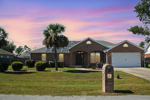 ranch-style house with a lawn and a garage