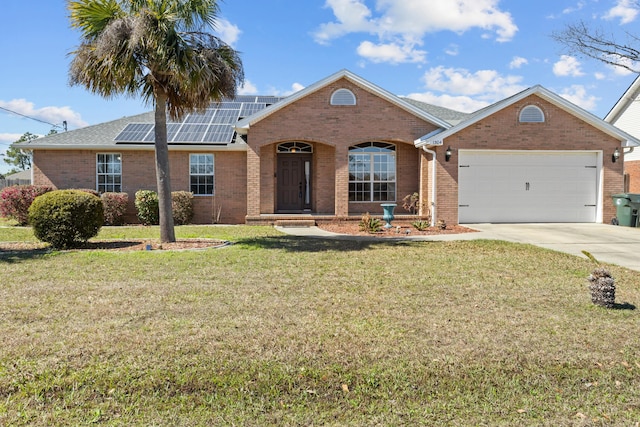 ranch-style house featuring a front lawn, solar panels, and a garage