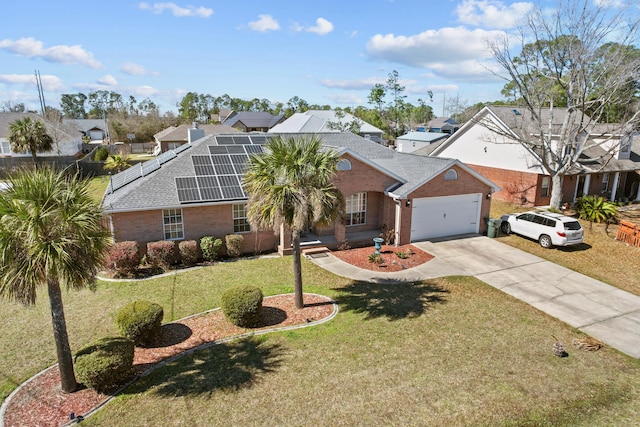 view of front of property with a front yard, a garage, and solar panels