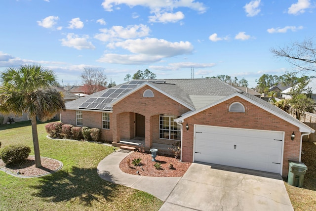 ranch-style house with a front yard and solar panels