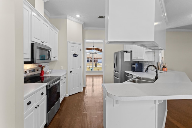 kitchen with appliances with stainless steel finishes, a breakfast bar area, and kitchen peninsula