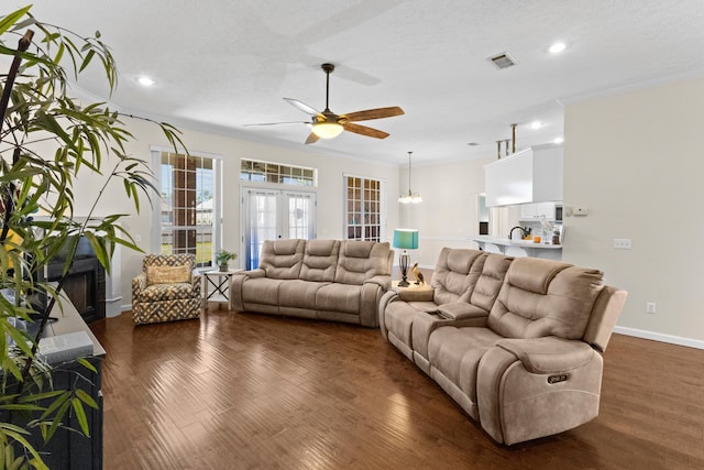 living room featuring ornamental molding, dark hardwood / wood-style floors, and french doors