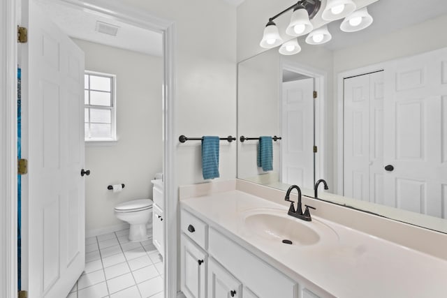 bathroom featuring toilet, vanity, and tile patterned flooring