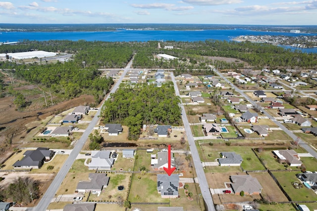 birds eye view of property with a water view