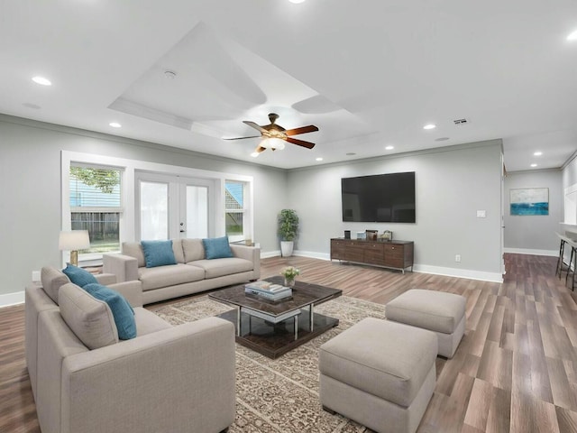 living room featuring ceiling fan, a healthy amount of sunlight, wood-type flooring, and french doors