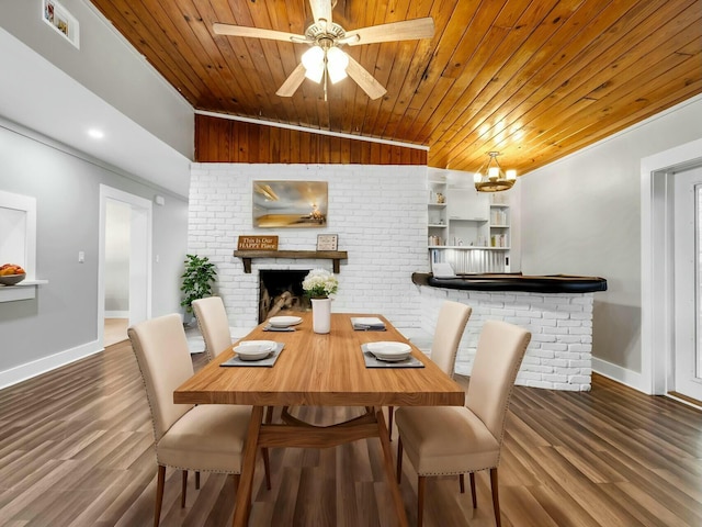 dining area with a fireplace, ceiling fan with notable chandelier, hardwood / wood-style flooring, and wooden ceiling