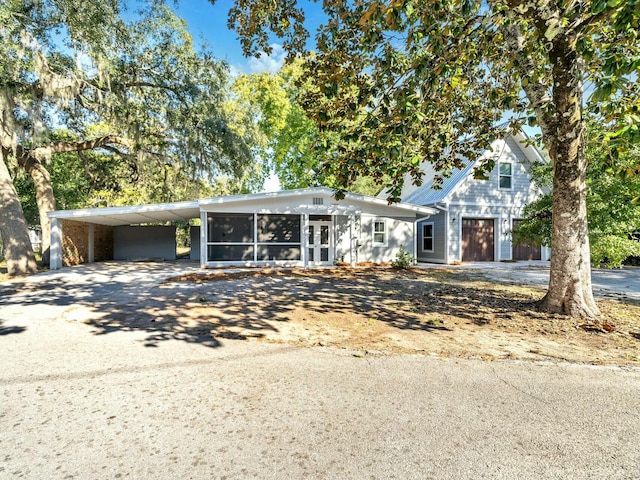 view of front of property with a carport and a sunroom