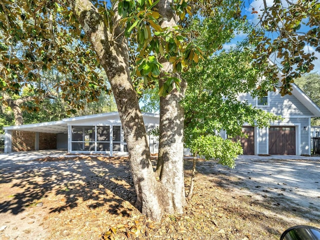 view of front facade with a sunroom and a carport