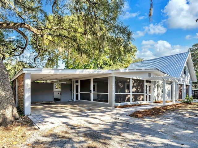 view of front of house featuring a carport and a sunroom