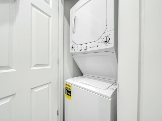 laundry area featuring stacked washing maching and dryer