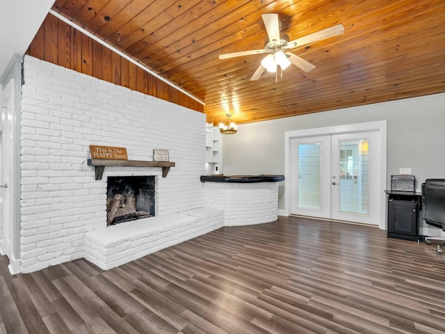 unfurnished living room featuring lofted ceiling, french doors, a brick fireplace, dark hardwood / wood-style floors, and wood ceiling