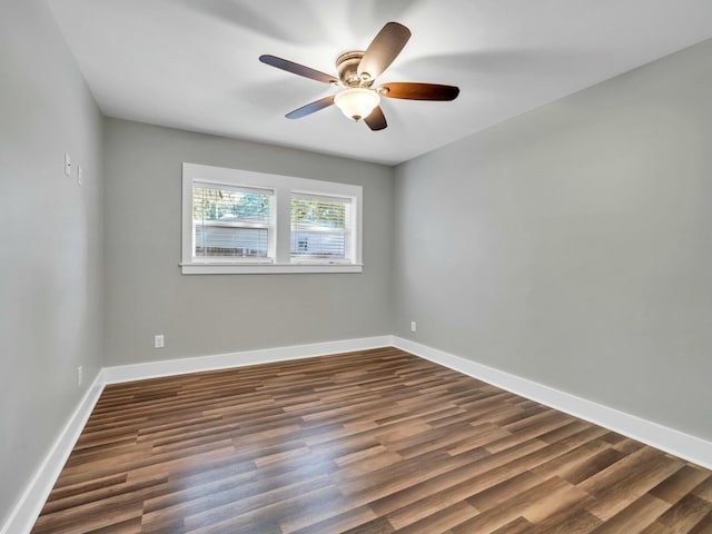 unfurnished room with ceiling fan and dark wood-type flooring