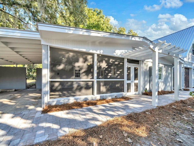 exterior space with a pergola and a sunroom