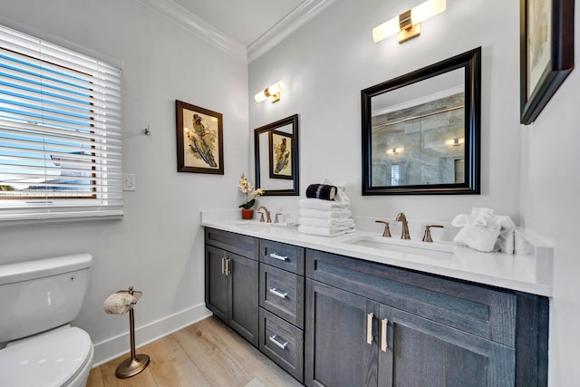 bathroom with wood-type flooring, ornamental molding, toilet, and double sink vanity