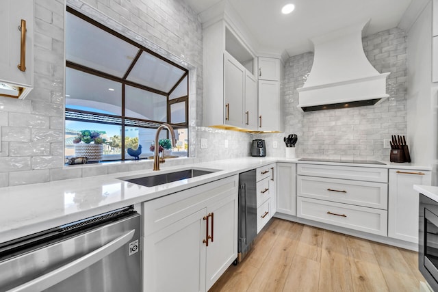 kitchen featuring light hardwood / wood-style floors, dishwasher, custom exhaust hood, and white cabinetry