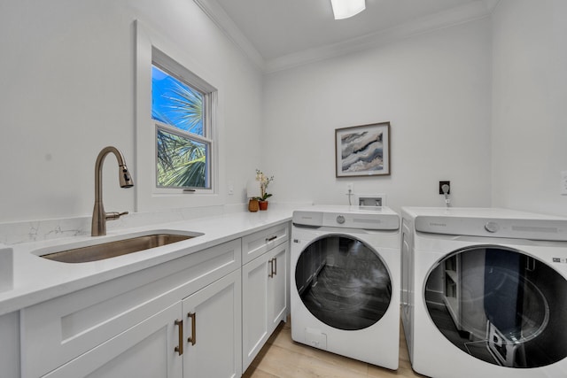 washroom with washer and dryer, cabinets, sink, hookup for an electric dryer, and light hardwood / wood-style flooring