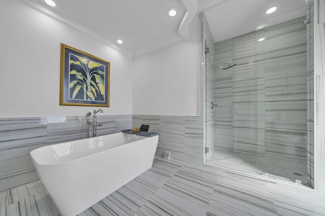 bathroom with independent shower and bath, crown molding, tile flooring, and tile walls