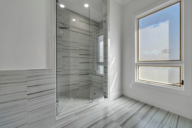 bathroom with an enclosed shower and tile flooring