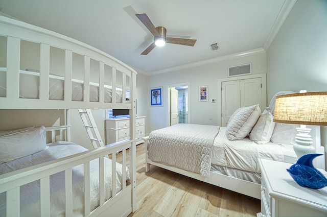 bedroom featuring light hardwood / wood-style flooring, ceiling fan, and ornamental molding