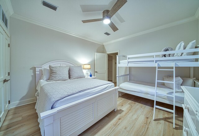 bedroom with ceiling fan, light hardwood / wood-style floors, and ornamental molding