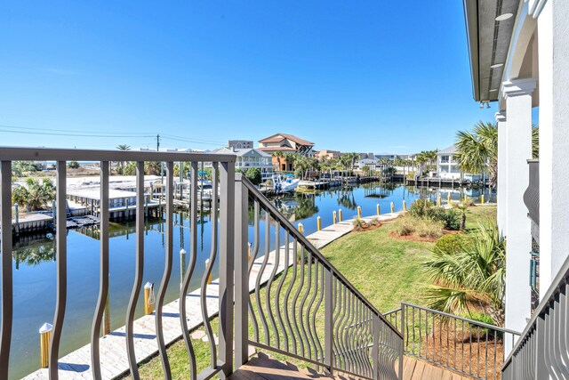 balcony with a dock and a water view