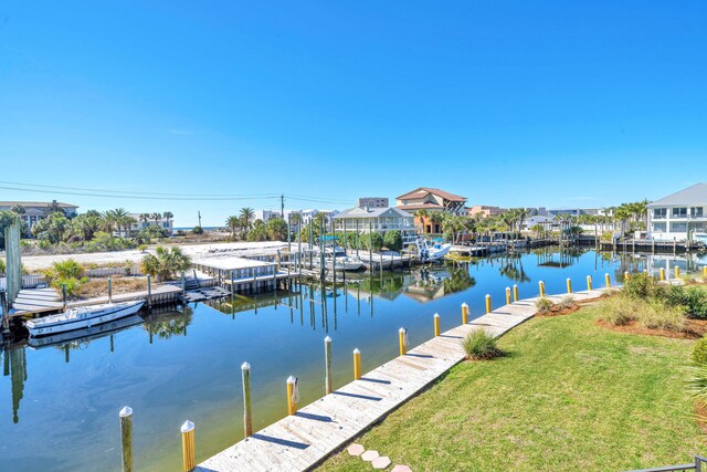 dock area featuring a water view and a lawn