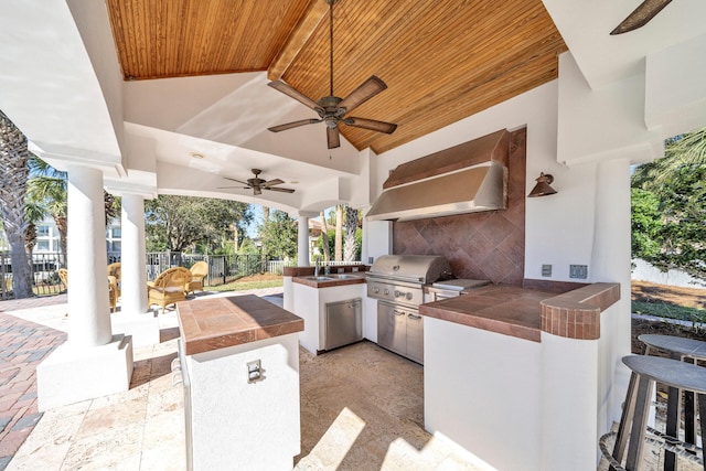 view of patio with a grill, sink, ceiling fan, and area for grilling