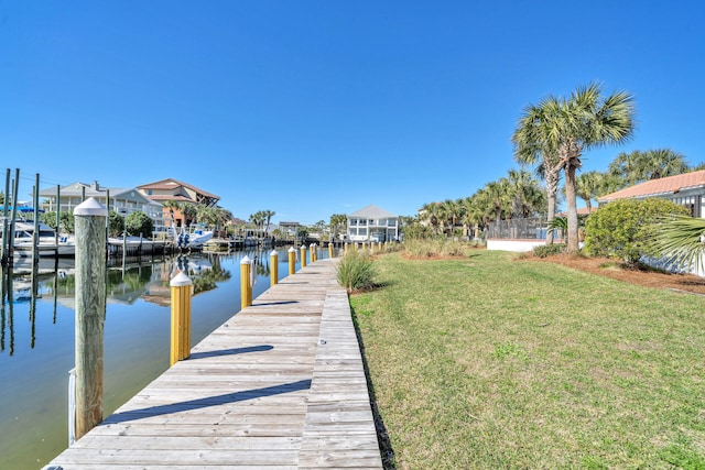 dock area featuring a water view and a yard