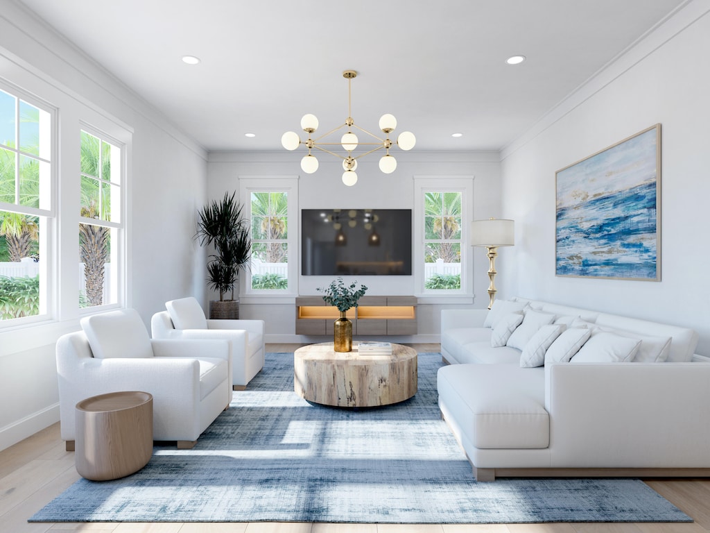 living room with light hardwood / wood-style floors, crown molding, and an inviting chandelier