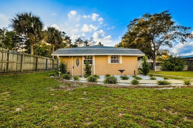 exterior space with a lawn and an outbuilding