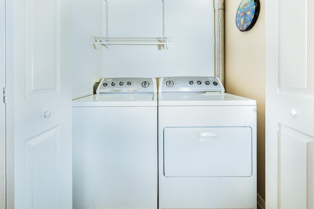 clothes washing area with washing machine and clothes dryer