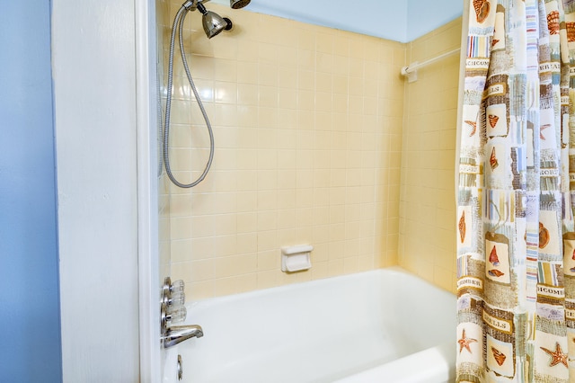 bathroom with shower / bath combo with shower curtain