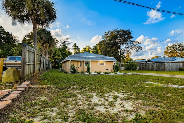 back of house featuring a yard