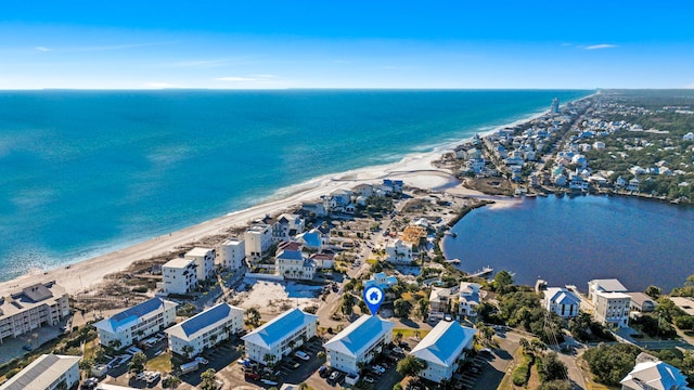 drone / aerial view featuring a water view and a beach view