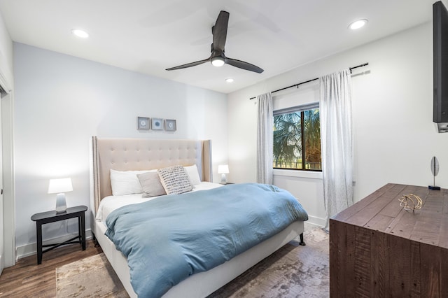 bedroom with dark wood-type flooring and ceiling fan