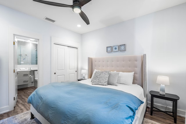 bedroom with a closet, ceiling fan, ensuite bathroom, and dark hardwood / wood-style floors