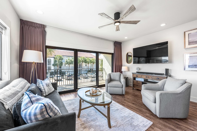 living room with dark hardwood / wood-style floors and ceiling fan