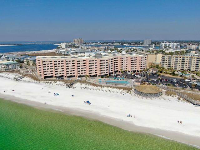 drone / aerial view with a city view, a water view, and a beach view