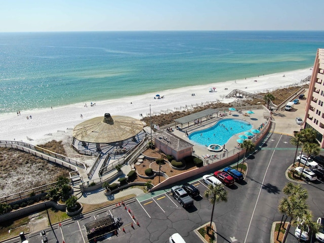 bird's eye view featuring a water view and a beach view